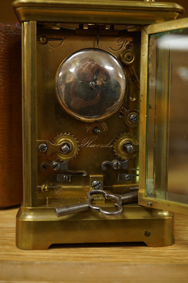 A French brass cased repeating carriage clock, striking on a bell, with key and case, 16cm high. Condition - fair, untested